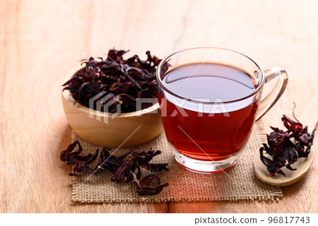 Roselle tea in cup glass with dry roselle on wooden background, Herbal drink Roselle tea in cup glass with dry roselle on wooden background, Herbal drink 96817743