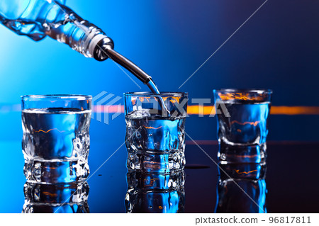 vodka in bar on a black  background vodka in bar on a black  background 96817811