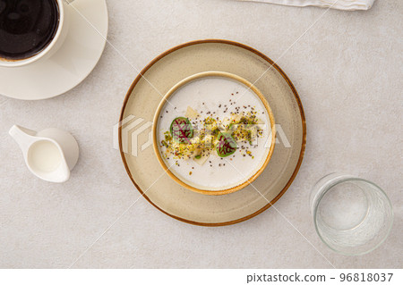 Portion of porridge with pears and herbs 96818037