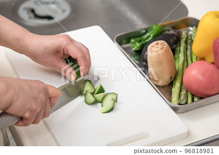 [Cucumber is cut into pieces with a Santoku knife] 96818981