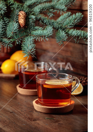 Tea with lemon on a wooden table. 96819100