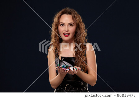 Casino concept. Portrait of young pretty caucasian woman, playing in casino. Roulette, poker chips, cards, wheel, isolated white background 96819475
