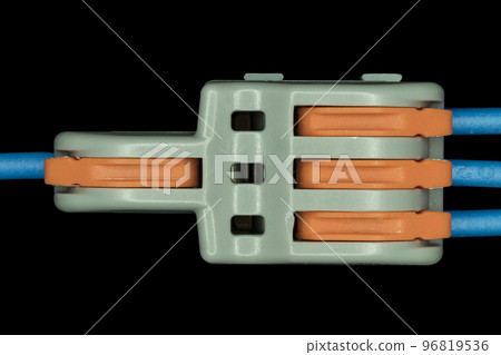 Compact splicing connector isolated on black background. 96819536