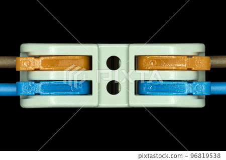 Compact splicing connector isolated on black background. 96819538