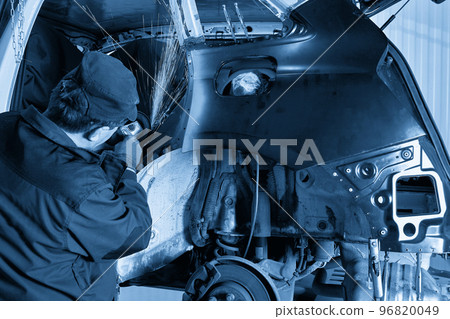 Repair service worker fix damaged car. Working with angle grinder to fix metal body. Repair service worker fix damaged car. Working with angle grinder to fix metal body. 96820049