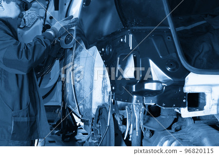 Repair service worker fix damaged car. Working with angle grinder to fix metal body. Repair service worker fix damaged car. Working with angle grinder to fix metal body. 96820115