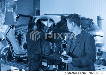 Auto mechanic and technician working in repair shop 96820138