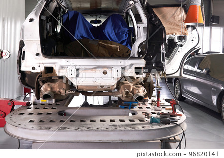 Car standing on a lift platform for repair in auto service shop Car standing on a lift platform for repair in auto service shop 96820141