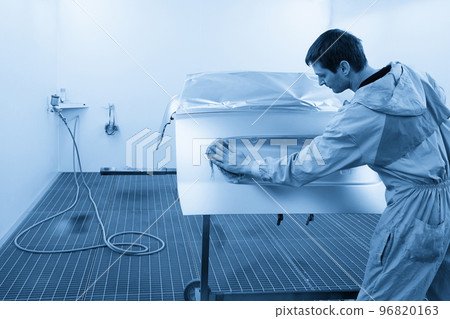 Auto mechanic preparing the car for paint job in painting booth in auto repair shop Auto mechanic preparing the car for paint job in painting booth in auto repair shop 96820163