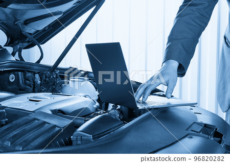 Car mechanic using computer in auto repair shop Car mechanic using computer in auto repair shop 96820282