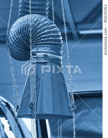 Hood of an industrial air extractor in auto repair shop Hood of an industrial air extractor in auto repair shop 96820363