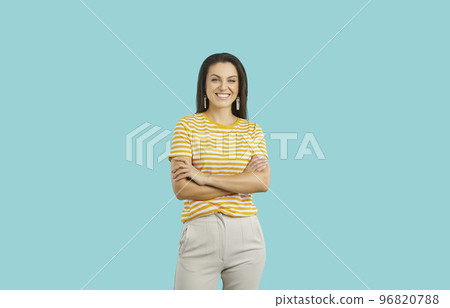 Happy attractive young woman in casual outfit standing isolated on blue background 96820788