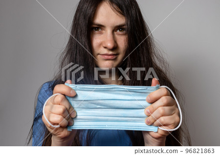 Female doctor holding a medical mask. Surgery. Female doctor holding a medical mask. Surgery. 96821863
