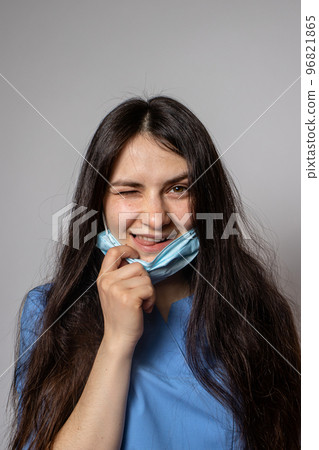 Woman doctor removes the mask from the face. Woman doctor removes the mask from the face. 96821865