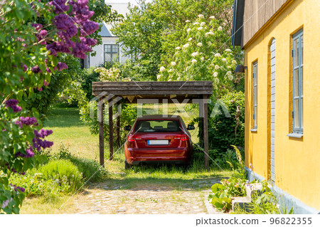 Image of Swedish summer house with wooden carport in the garden 96822355