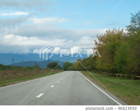 Highway through the autumn forest natural way concept, road to the caucasian forest nature field, relaxing with ecological environment. Mountain Digoria is a national park in North Ossetia 96823050