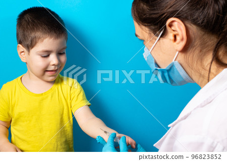 A doctor or nurse does a Mantoux test for a small baby boy. Tuberculosis test, vaccination. Intradermal tuberculin injection 96823852