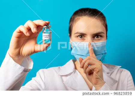A doctor or laboratory technician holds a test tube with a vaccine against diseases. Vaccination against covid-19 coronavirus. Pandemic in the world, the invention of the vaccine A doctor or laboratory technician holds a test tube with a vaccine against diseases. Vaccination against covid-19 coronavirus. Pandemic in the world, the invention of the vaccine 96823859