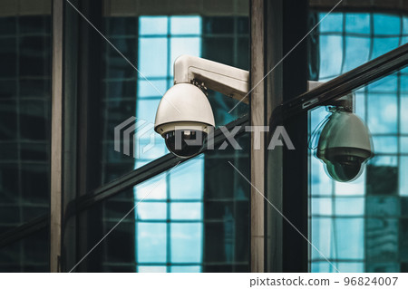 Security camera outdoors, surveillance 360 degree camera on modern building facade 96824007
