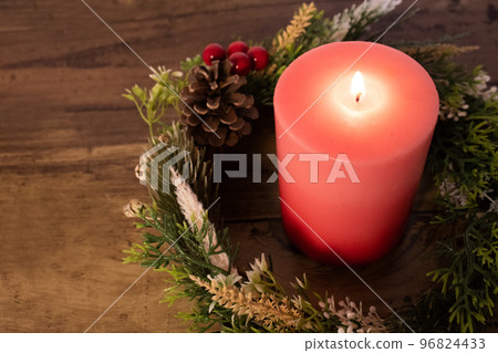 Pink candles and natural Christmas wreath 96824433