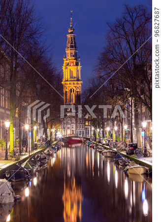 Beautiful old houses on the city waterfront of Amsterdam at sunset. 96827687