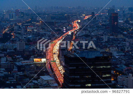 Aerial view of busy cars with traffic jam in the rush hour on highway road street on bridge in Bangkok Downtown, urban city in Asia, Thailand at sunset. Intersection junction. Toll gate in Rama 9 Aerial view of busy cars with traffic jam in the rush hour on highway road street on bridge in Bangkok Downtown, urban city in Asia, Thailand at sunset. Intersection junction. Toll gate in Rama 9 96827791