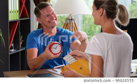 Pharmacist explaining how to take medication to patient. 96828555