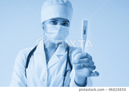Young female doctor showing thermometer over white background, studio shot Young female doctor showing thermometer over white background, studio shot 96828850
