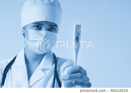 Young female doctor showing thermometer over white background, studio shot 96828928