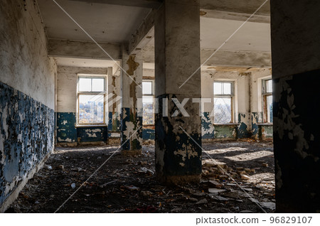 abandoned and destroyed offices and halls, a destroyed industrial building, a house with broken windows, old destroyed houses. 96829107