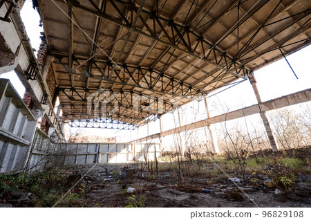 An abandoned warehouse that has been destroyed by people and time. 96829108