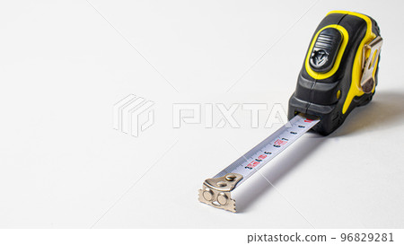 Measuring roulette yellow black on a white background banner with space for text. A construction tool tape measure 96829281