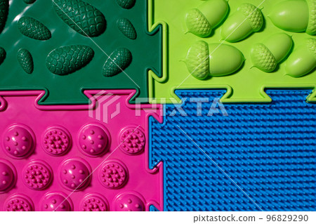 Orthopedic mats view from above. Bright colorful multicolored mats to prevent flat feet and foot massage. Orthopedic mats view from above. Bright colorful multicolored mats to prevent flat feet and foot massage. 96829290
