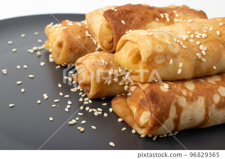 Closeup on dish of foie gras with country style sesame crispy french bread and blini russian pancake isolated on white Closeup on dish of foie gras with country style sesame crispy french bread and blini russian pancake isolated on white 96829365