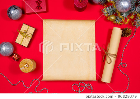 Parchment paper for the to-do list and text and a candle for the new year 2021 on a red background. Christmas, holiday card with plans for next year 96829379