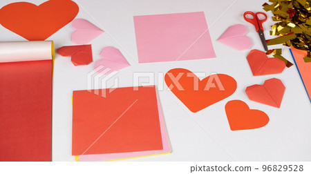 Making origami hearts for Valentine's Day. Crafts made of paper with your own hands. 96829528