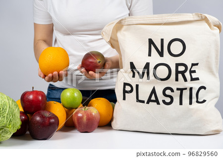 A woman puts products in a fabric eco bag with no more plastic. The concept of rejection of plastic 96829560