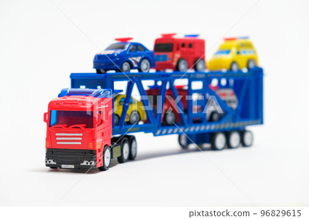 Toy car transporter with cars on a white background with place for text, copy space, for a toy store. Toy car transporter with cars on a white background with place for text, copy space, for a toy store. 96829615