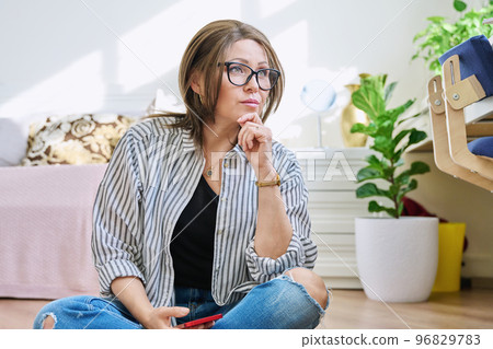 Portrait of confident mature woman at home Portrait of confident mature woman at home 96829783