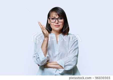 Emotional talking mature woman looking at camera on white background Emotional talking mature woman looking at camera on white background 96830303