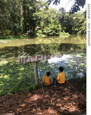 Two Children Sitting Fishing Lake Two Children Sitting Fishing Lake 96830304