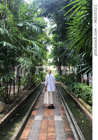 Girl Stand Back In Tropical Street 96830321