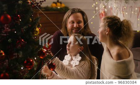 Family decorating Christmas tree with branches 96830384