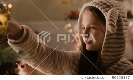 Young girl choosing toys for Christmas tree Young girl choosing toys for Christmas tree 96830387