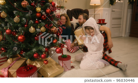 Happy family opening gifts on Christmas together Happy family opening gifts on Christmas together 96830446