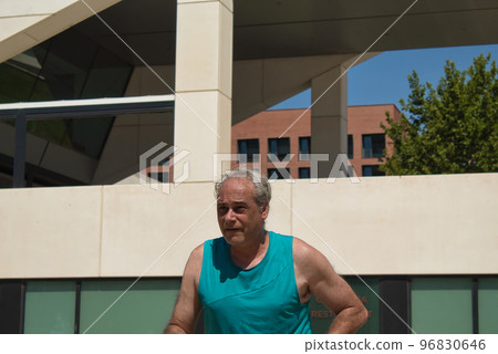 mature man training on the street with sports machine mature man training on the street with sports machine 96830646