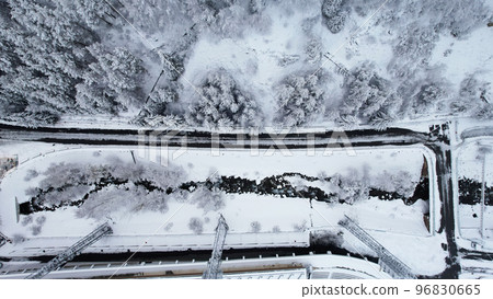 Snowy fairy-tale road in the mountain forest Snowy fairy-tale road in the mountain forest 96830665