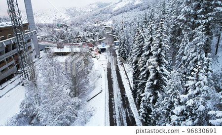Snowy fairy-tale road in the mountain forest Snowy fairy-tale road in the mountain forest 96830691