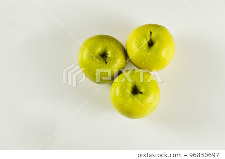 top view of three green apples with drops on white background top view of three green apples with drops on white background 96830697