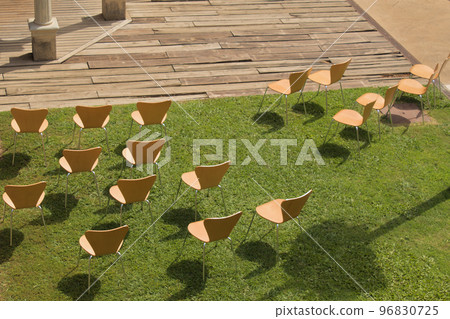 separate chairs on the lawn set up for a covid restricted celebration 96830725
